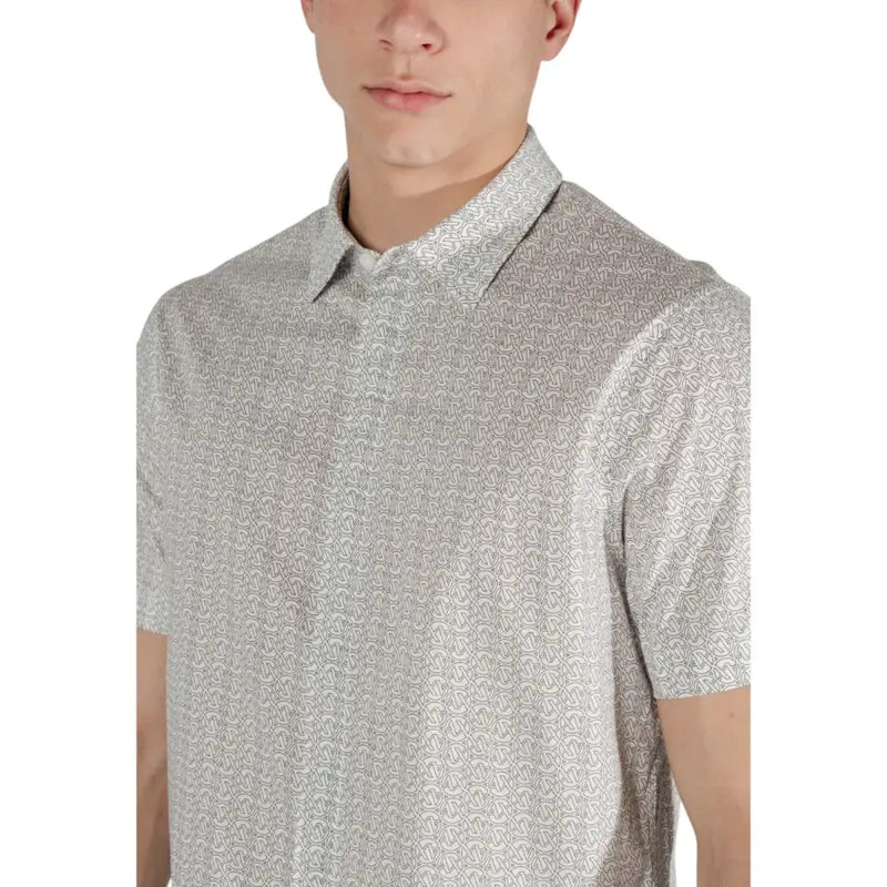 Light gray short-sleeved polo shirt with subtle repeating monogram pattern from armani exchange beige geometric collection