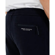 Back side view of black Armani Exchange jogger pants with zippered back pocket and white logo lettering for fall winter