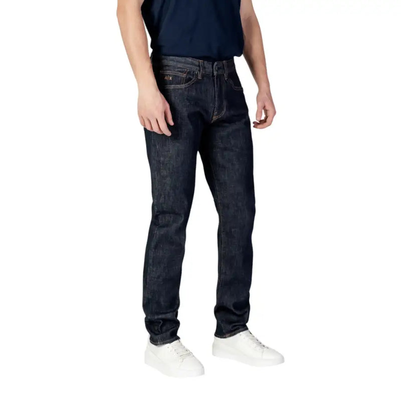 Dark blue slim fit jeans with white stitching and a faded wash design, likely from g-star raw.