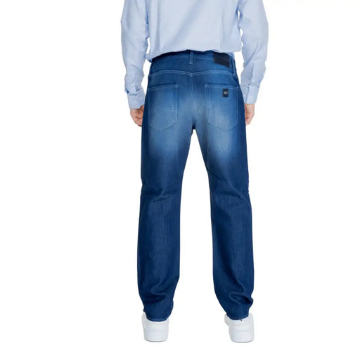 Blue denim jeans with a relaxed fit and white stitching.