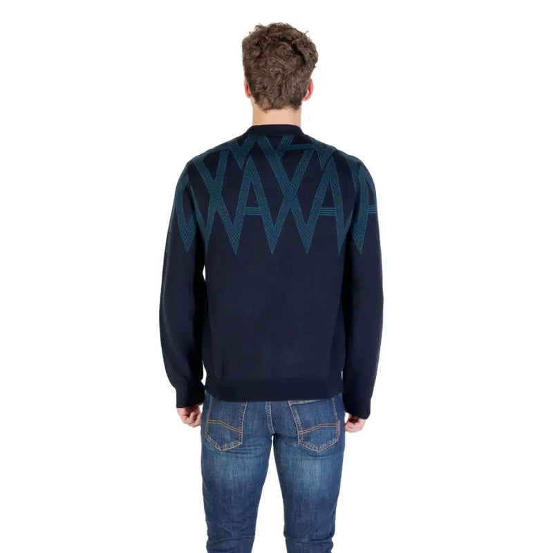 Navy blue sweater with teal zigzag pattern and crew neck.
