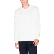 White crew neck sweater with long sleeves and ribbed cuffs, likely made of cotton or a similar soft material.