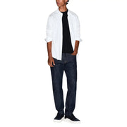 Un homme portant un Armani Exchange T-shirt noir en coton pour homme, porté avec une chemise blanche, un jean bleu foncé et des baskets noires.