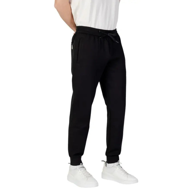 Armani Exchange men black plain laced trousers featuring sleek tapered fit and subtle side pockets in drawstring joggers