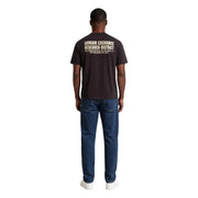Armani Exchange T-shirt homme en coton marron, dos visible avec tissu noir et texte beige « Research District ».