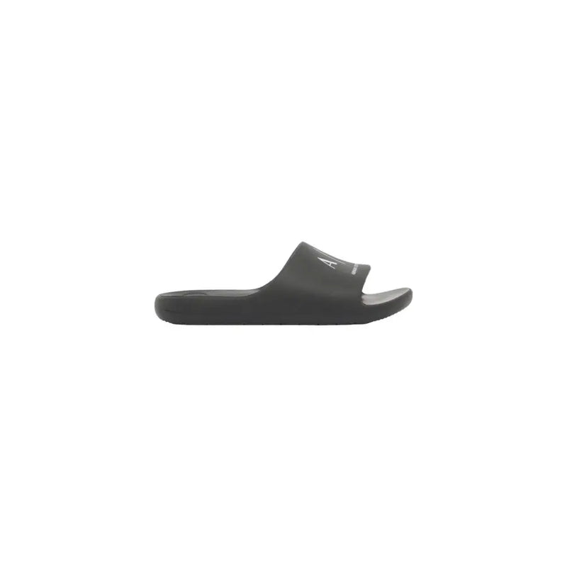 Sandales Calvin Klein noires à enfiler, au design minimaliste et au logo blanc discret sur la bride, pour hommes, style mules en caoutchouc