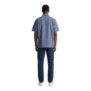 Un homme portant un armani exchange chemise en coton bleu clair à manches courtes et jean en denim foncé