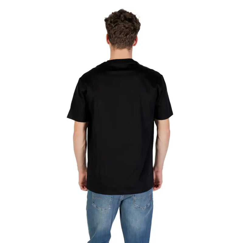 Men’s black short-sleeved cotton T-shirt paired with blue jeans from Armani Exchange