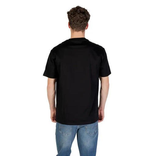 Men’s black short-sleeved cotton T-shirt paired with blue jeans from Armani Exchange