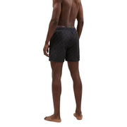 Armani Exchange men swimwear black swim trunks with a subtle lighter geometric pattern for stylish beachwear