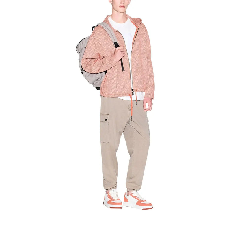 Armani Exchange men t shirt paired with a light pink textured zip up hoodie featuring matching drawstring and ribbed cuffs