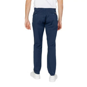 Back view of navy blue chino trousers with buttoned back pockets and subtle brand tag on right hip from Armani Exchange spring summer collection