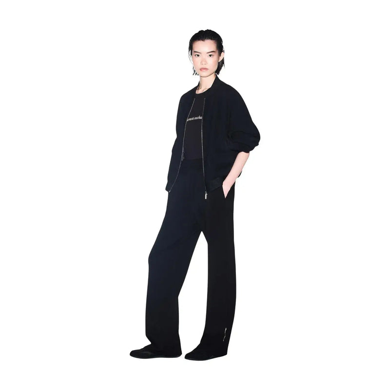 Black oversized bomber jacket with subtle silver embroidery and matching zipper details paired with armani exchange women black cotton round neck t shirt