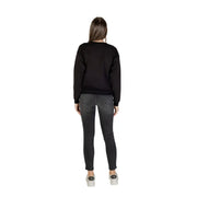 Armani Exchange women black printed long sleeve crewneck sweatshirt paired with dark gray skinny jeans front view
