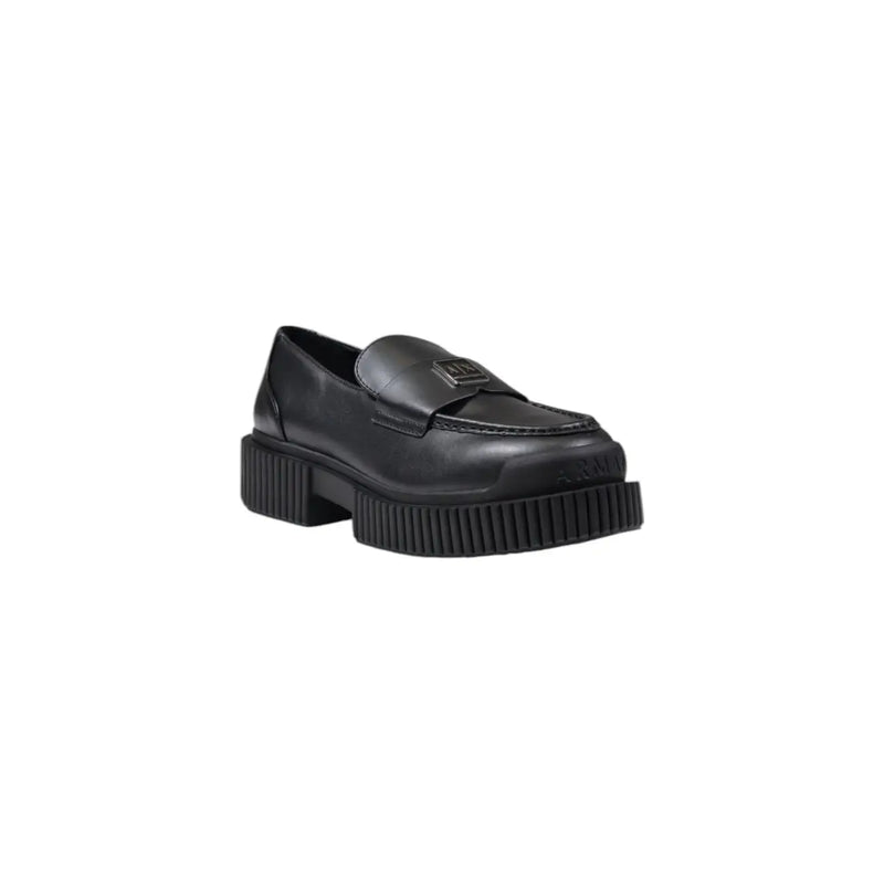 Armani Exchange women’s black leather moccasin slippers with chunky ribbed sole and metallic logo plaque on vamp