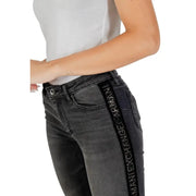 Women’s dark grey jeans with black side stripe and Armani Exchange branding for fall winter style