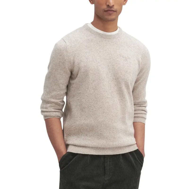 Beige textured sweater with ribbed cuffs and hem, likely made of cotton or wool.