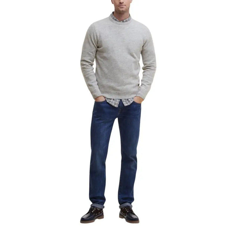 Gray crewneck sweater with ribbed cuffs and hem, dark blue jeans, black leather shoes.