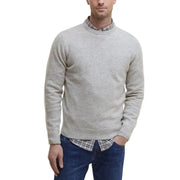 Light gray speckled crew neck sweater with plaid shirt collar and jeans.