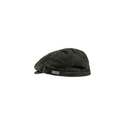 Tweed flat cap with a textured pattern and dark green color.