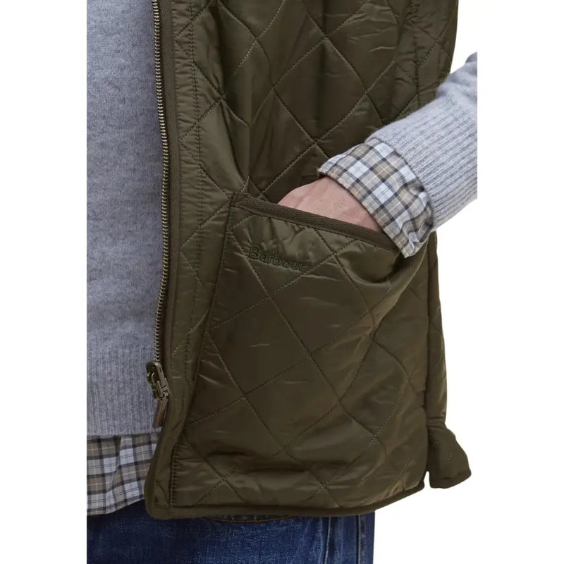 Olive green quilted vest with zipper closure and corduroy lining.
