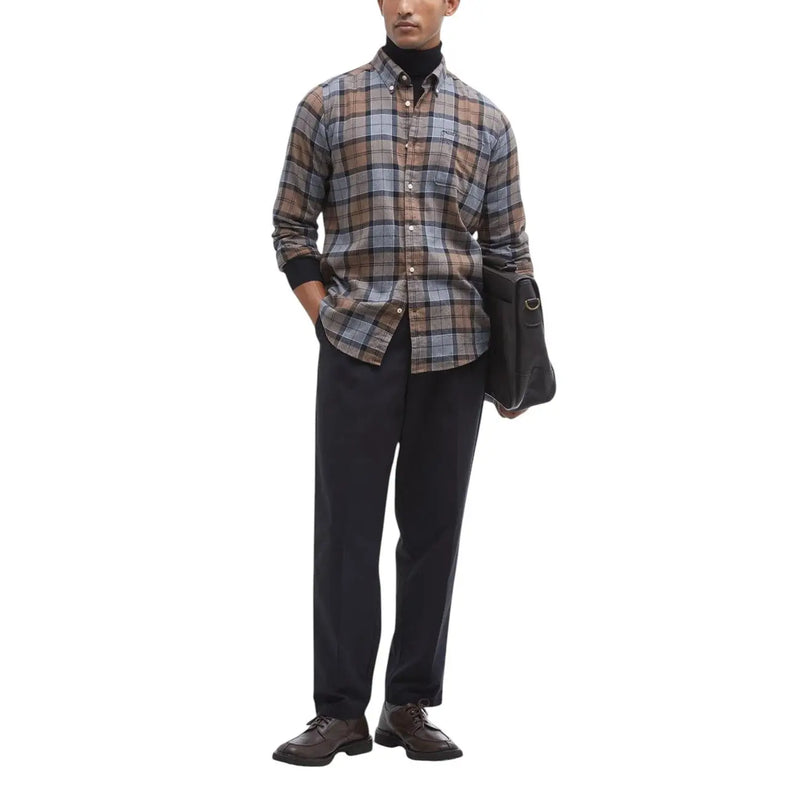 A man wearing a Barbour men shirt in brown gray and beige plaid with black cuffs and button-down design
