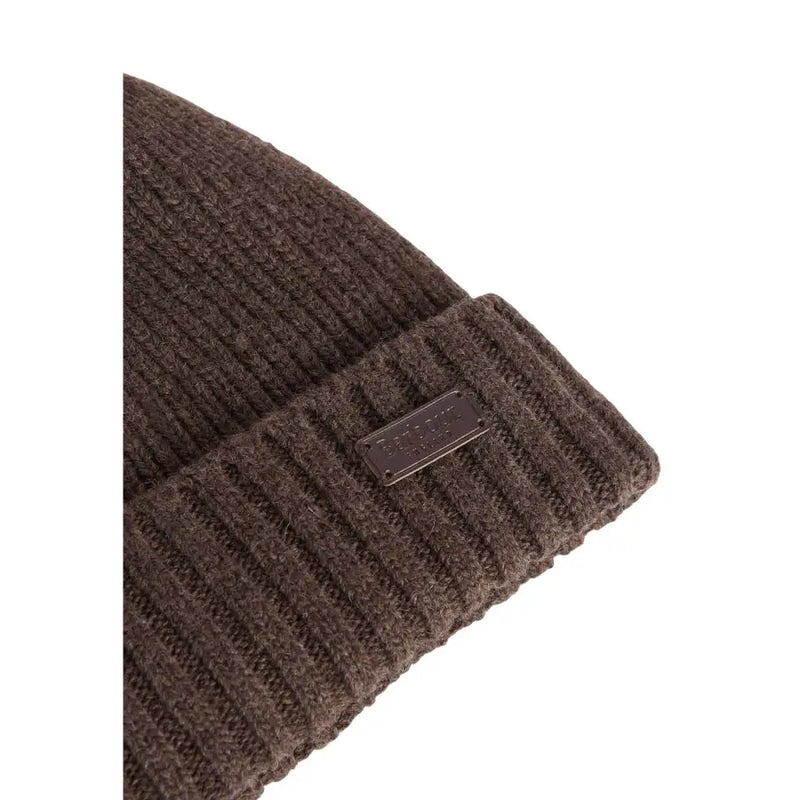 Brown ribbed knit beanie with metal tag detail.