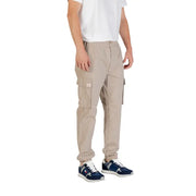 Beige cargo pants from Calvin Klein Jeans featuring side pockets and elastic cuffs for a comfortable fit