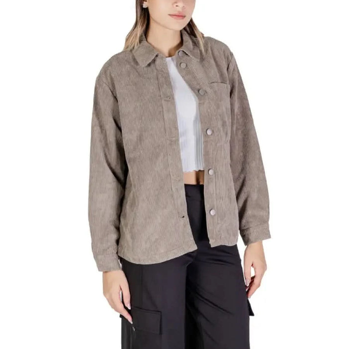 Beige corduroy button-up shirt jacket over white crop top from Jacqueline De Yong
