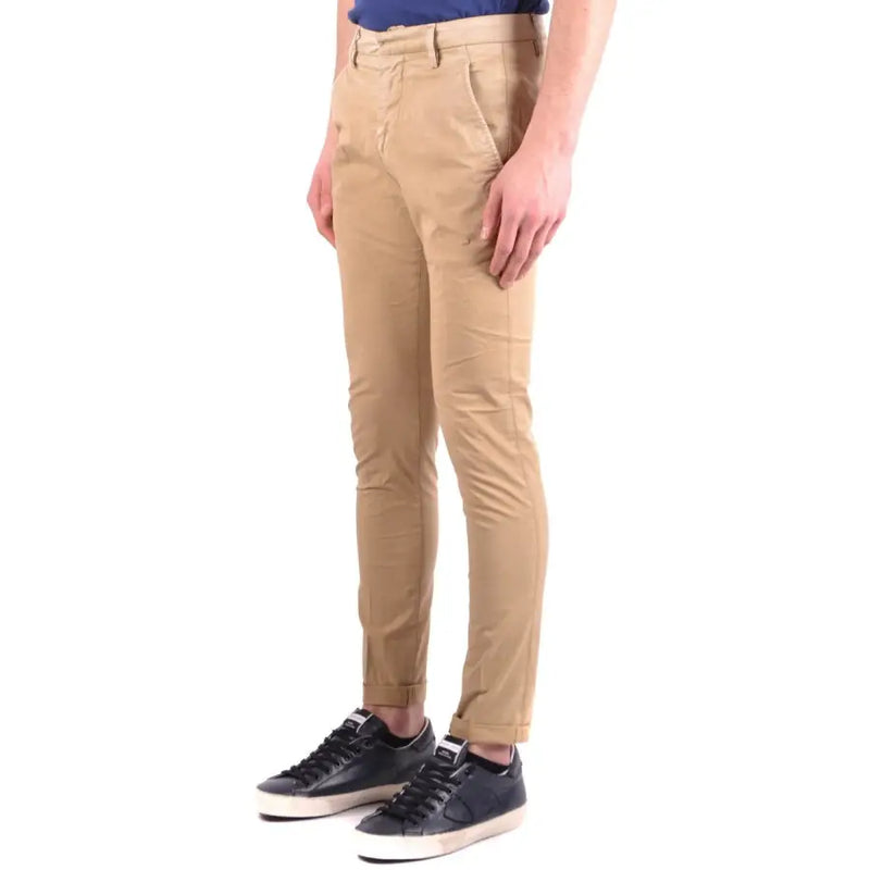 Men’s tan slim-fit chino pants with black sneakers from Beige Dondup Men Cotton Elastane collection