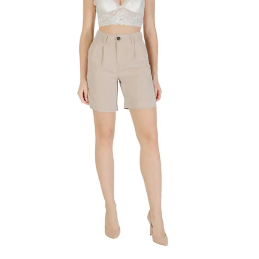 Beige high-waisted shorts and top for women displayed in a fashion catalog