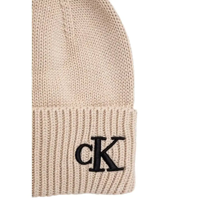 Beige knit beanie with black CK logo and pompom for stylish winter wear