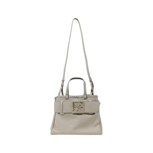 Beige leather handbag with shoulder strap and top handles featuring a buckle design