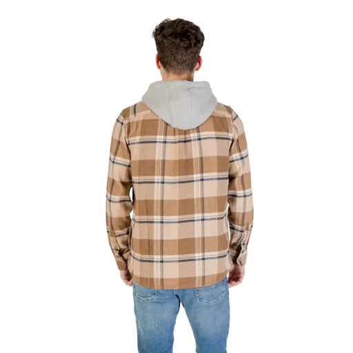Men’s brown plaid hooded shirt paired with blue jeans from Vans product lineup