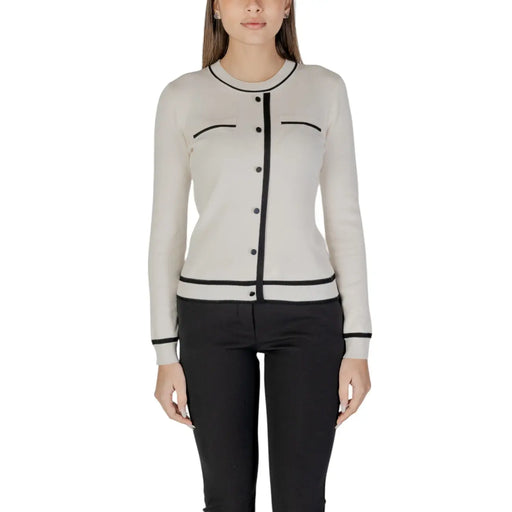 Beige long sleeve knit cardigan with black trim and front pockets