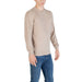 Beige long-sleeved sweater paired with Blue Jeans displayed in product image