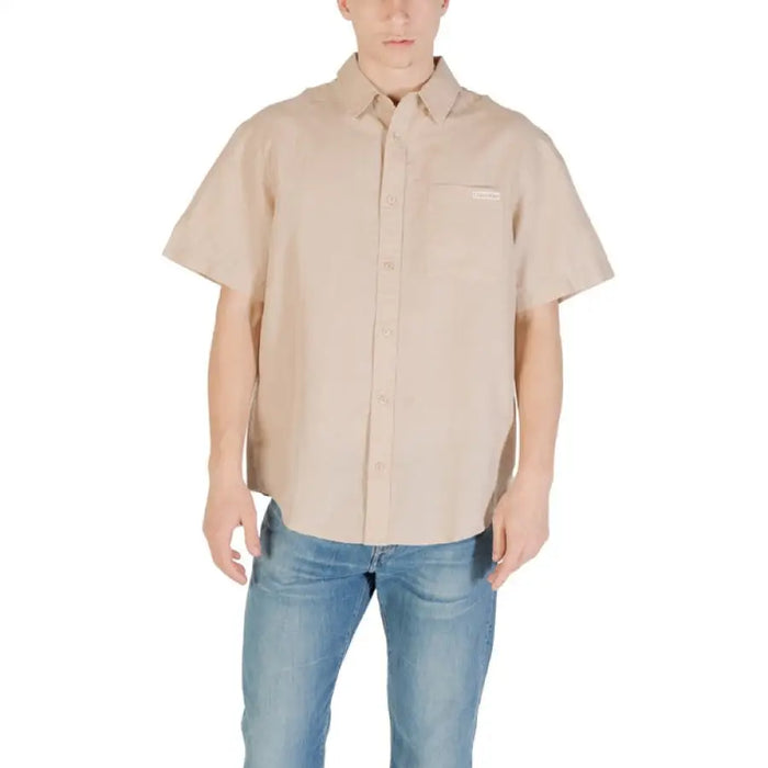 Beige short-sleeved button-down shirt displayed with Men White Short Sleeved Button Down Shirt and Khaki Pants