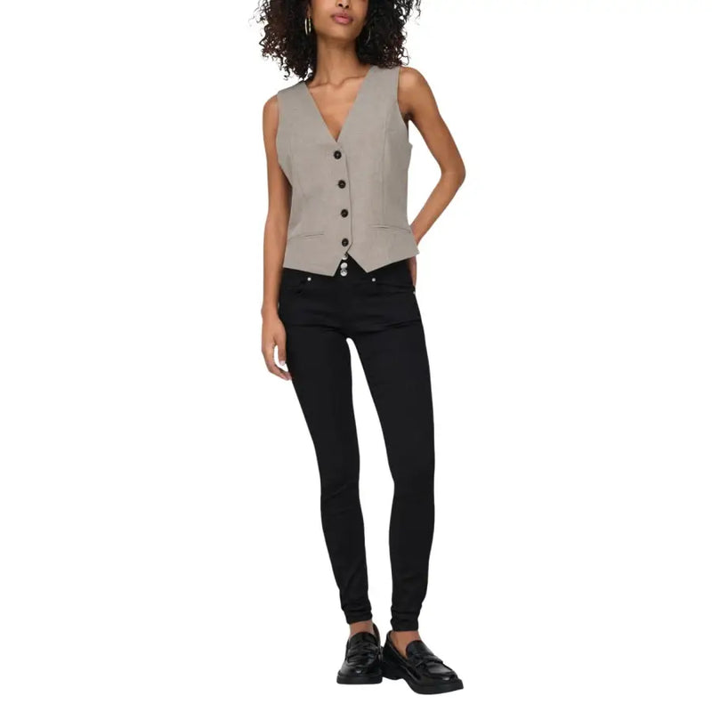 A sleek sleeveless gray vest with v neck and button closure designed as a beige sleeveless v neck gilet for women
