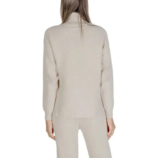 Beige turtleneck sweater and pants set by Clerè for women’s fashion