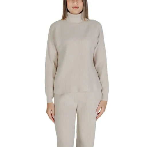 Clerè Women’s Beige Turtleneck Sweater with matching pants set displayed elegantly