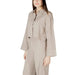 Beige two-piece open back pantsuit displayed in a product image for elegant formal wear