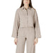 Beige two-piece open back pantsuit displayed as a stylish and elegant womenswear ensemble