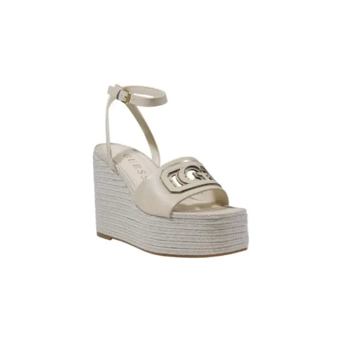 Beige wedge sandal with ankle strap from Guess Women, featuring buckle and bow design