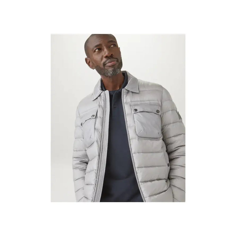 Polo Belstaff bleu en coton à manches longues pour homme, porté avec une doudoune matelassée gris clair à col structuré et poches à rabat.