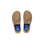 Mocassins Birkenstock pour homme en daim beige, modèle à enfiler, lacets assortis et semelle intérieure bleue avec logo de la marque.