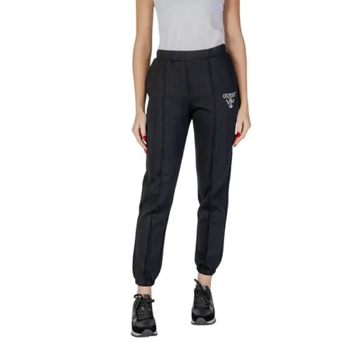 Black athletic jogger pants with elastic cuffed ankle and logo detail from Guess Active