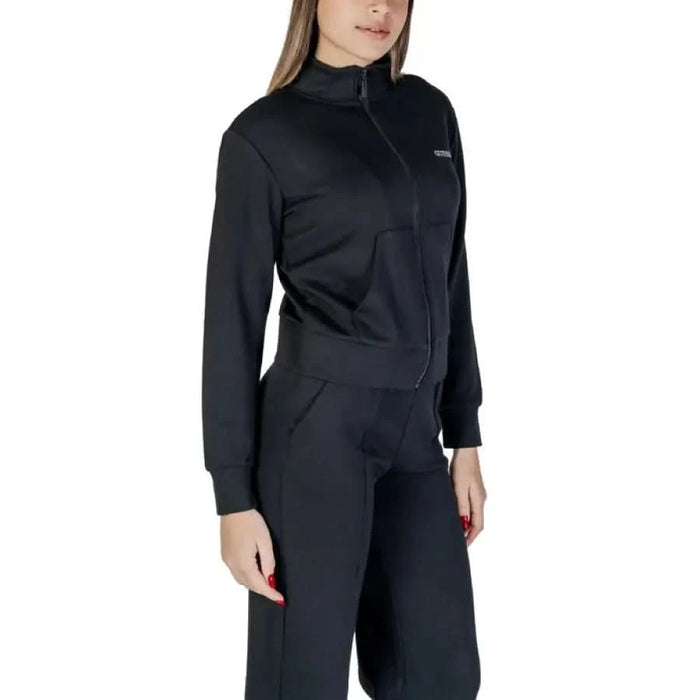 Black athletic jumpsuit with zip collar and long sleeves from Guess Active Women’s collection