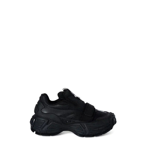 Black chunky Velcro athletic sneakers displayed in a modern sports shoe shop