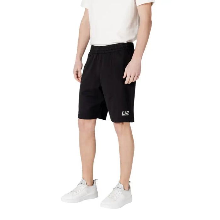 Black athletic shorts by EA7, featuring cotton material and convenient front pockets