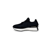 Black New Balance women’s sneakers with faux leather upper, white midsole, and black rubber lugged outsole